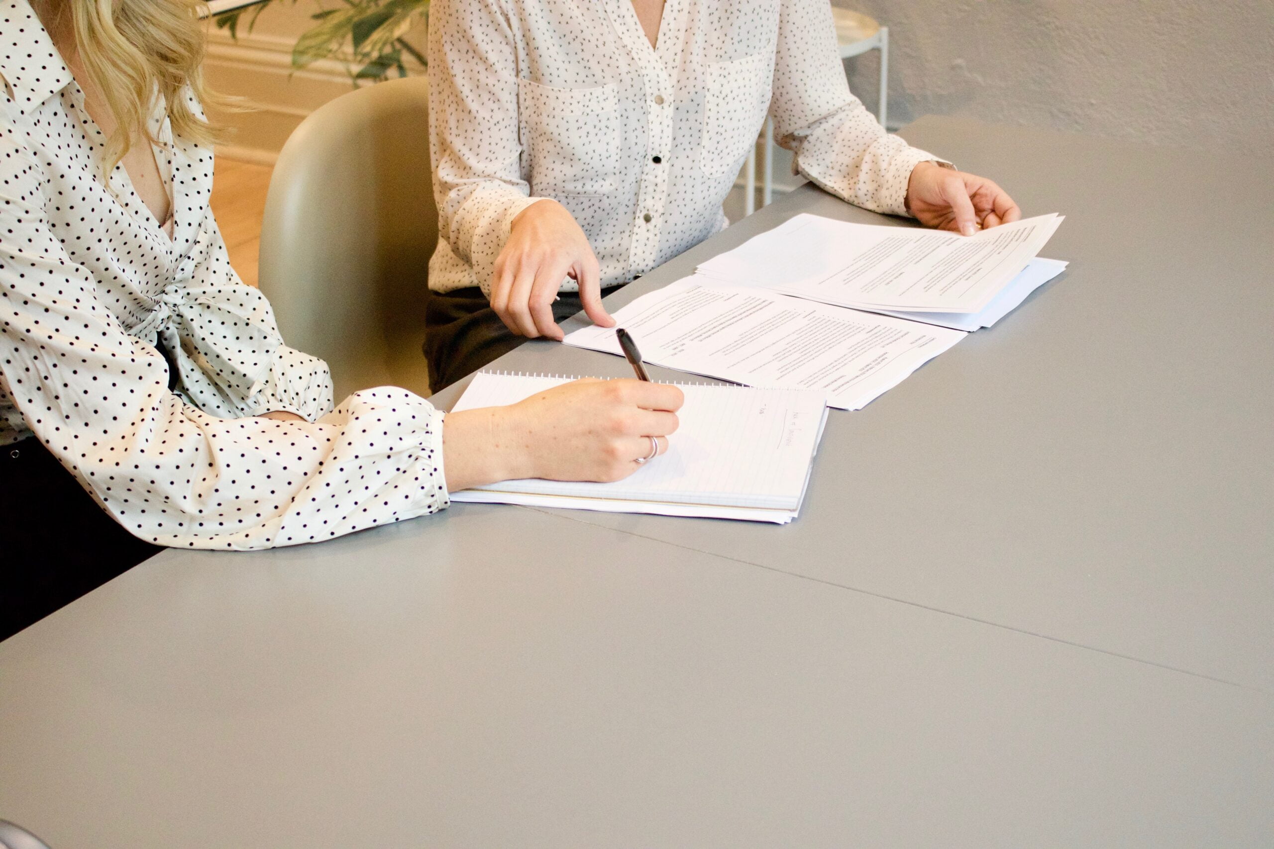 two people reviewing veterans documents at a table